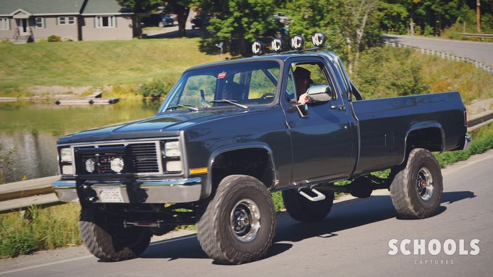 Blue-gray lifted GMC with roof lights